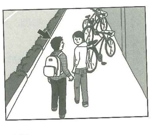 Two people walking toward parked bicycles, with one person unaware of them